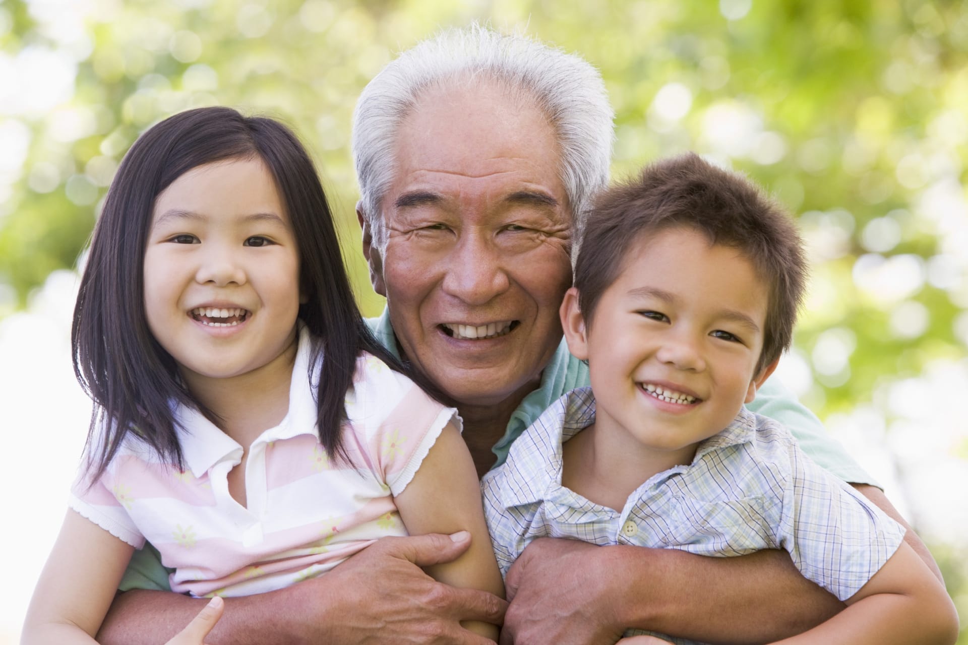 Loving multi-generation family enjoying outdoors together safely